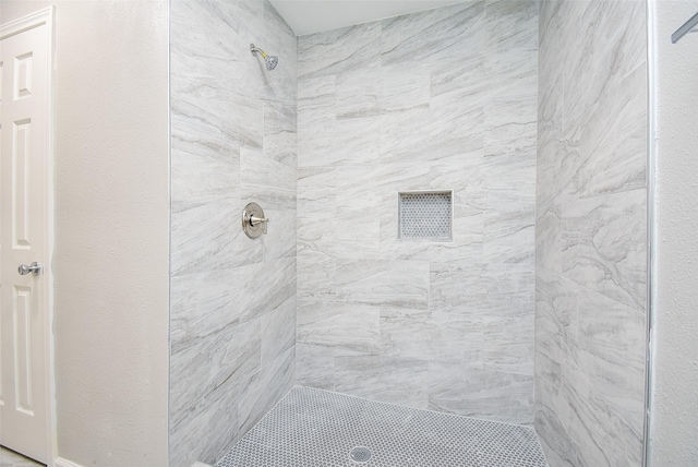 bathroom with a tile shower