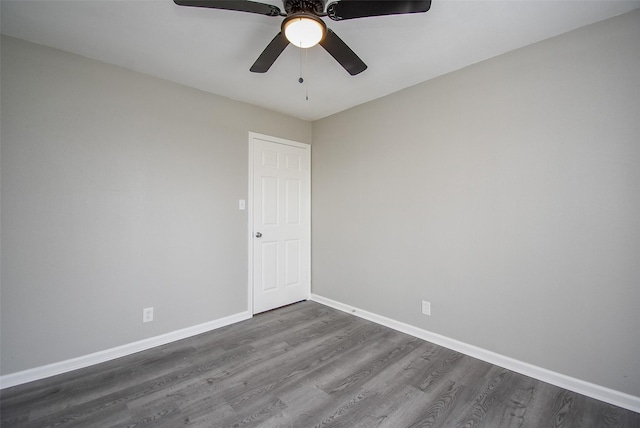 unfurnished room featuring ceiling fan and dark hardwood / wood-style flooring