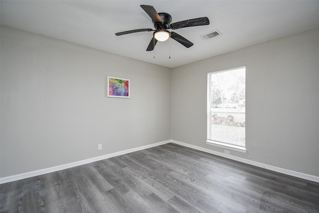 spare room featuring dark hardwood / wood-style floors and ceiling fan