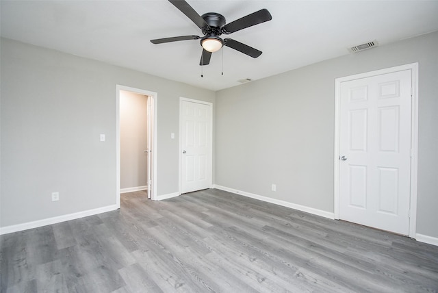 unfurnished bedroom featuring wood-type flooring and ceiling fan