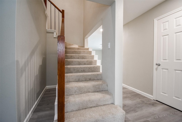 stairs featuring hardwood / wood-style floors