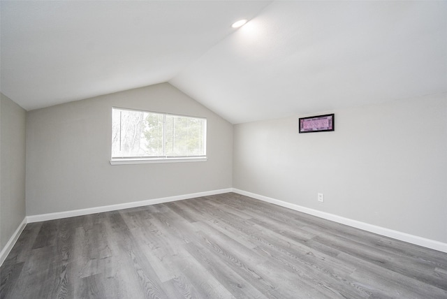 bonus room featuring hardwood / wood-style floors and vaulted ceiling