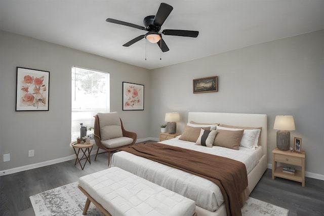 bedroom with dark hardwood / wood-style floors and ceiling fan