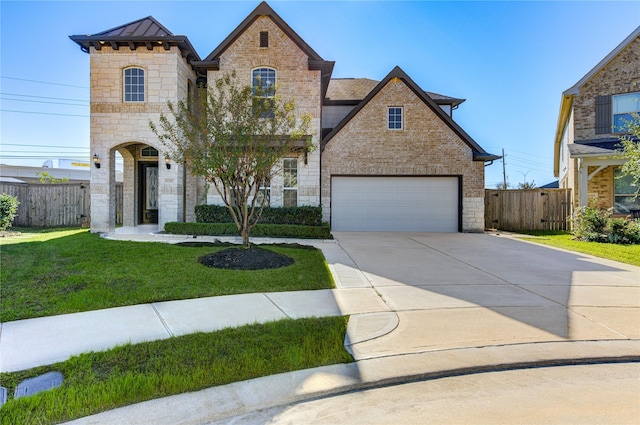 view of front of house featuring a front lawn and a garage