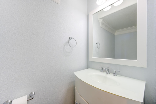 bathroom with vanity and ornamental molding