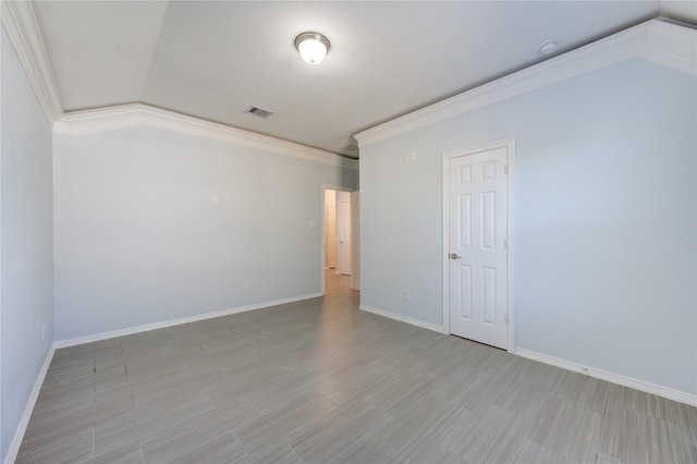 unfurnished room featuring crown molding, light hardwood / wood-style flooring, and vaulted ceiling