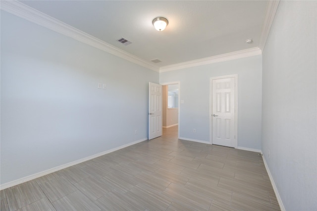 empty room featuring ornamental molding