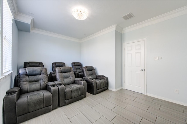 cinema with light hardwood / wood-style flooring and ornamental molding