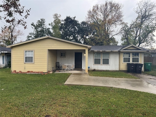 single story home featuring a front lawn and a carport