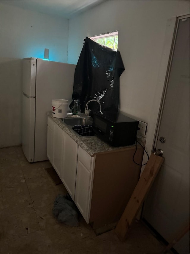 kitchen with white cabinetry and sink