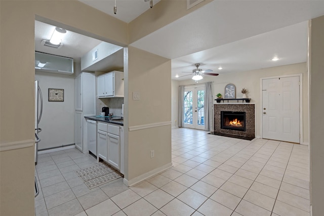 kitchen with white cabinetry, french doors, dishwasher, and light tile patterned floors