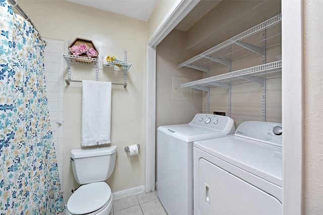 washroom with washer and dryer and light tile patterned flooring