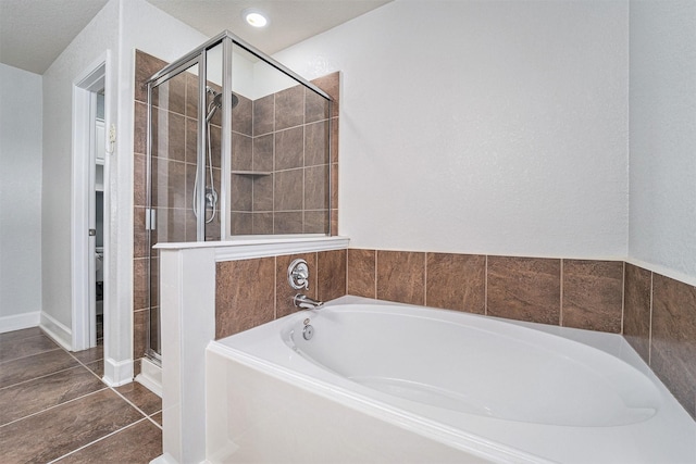 bathroom with toilet, tile patterned floors, and shower with separate bathtub