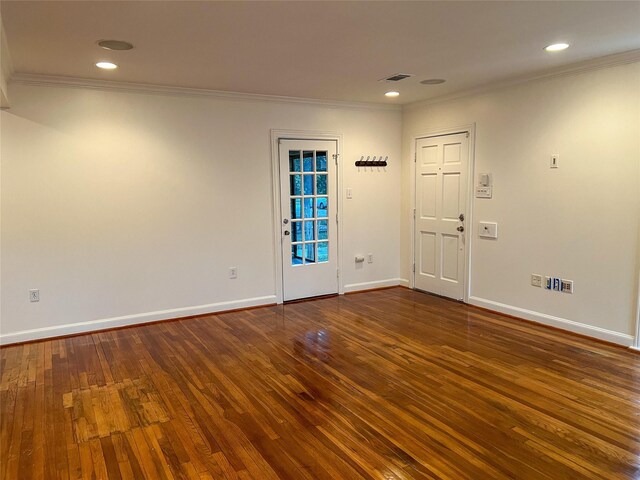 spare room featuring dark hardwood / wood-style floors and ornamental molding