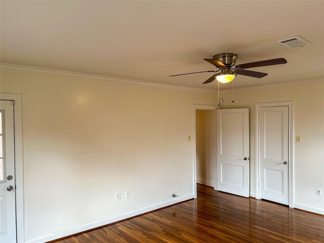 spare room with ceiling fan, dark hardwood / wood-style flooring, and crown molding