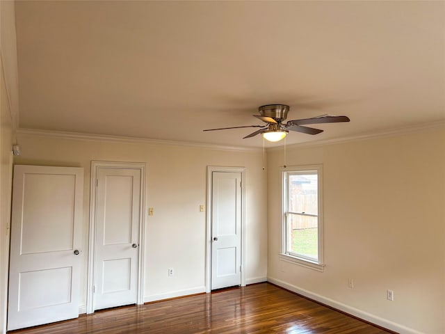 unfurnished bedroom featuring ceiling fan, dark hardwood / wood-style flooring, and crown molding