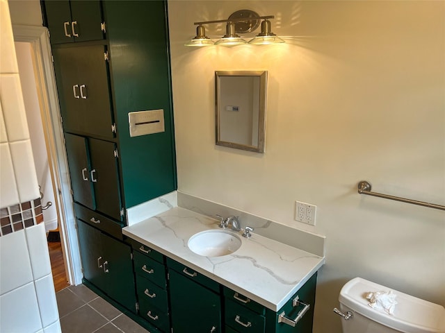 bathroom with tile patterned flooring, vanity, and toilet