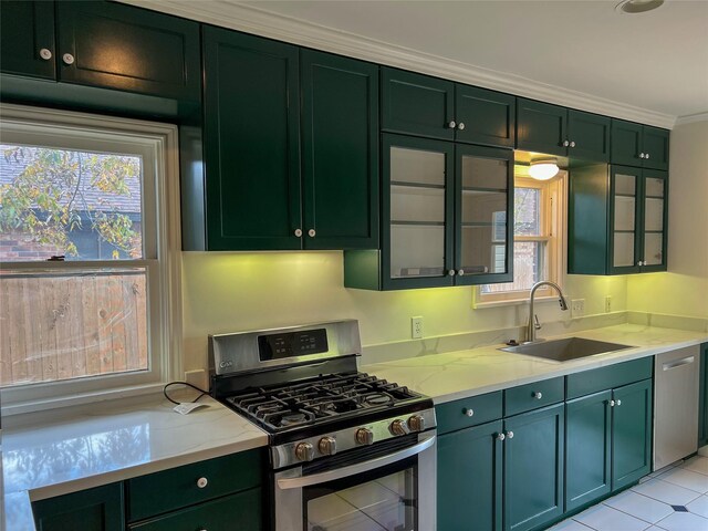 kitchen with crown molding, sink, stainless steel appliances, and plenty of natural light