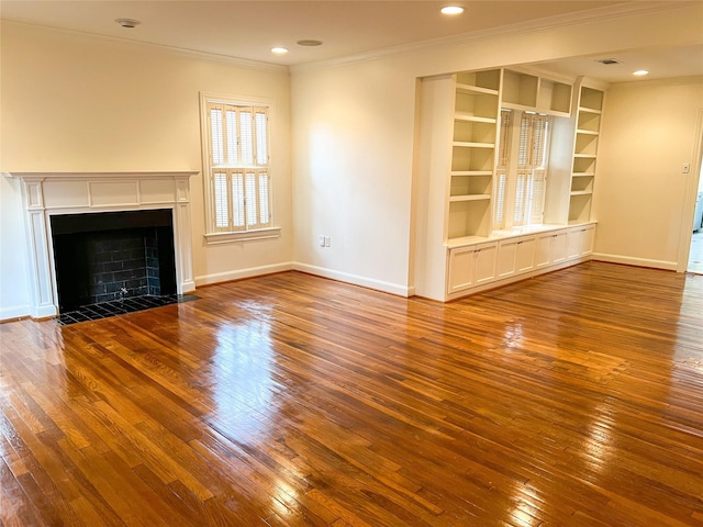 unfurnished living room featuring built in shelves, ornamental molding, and hardwood / wood-style floors