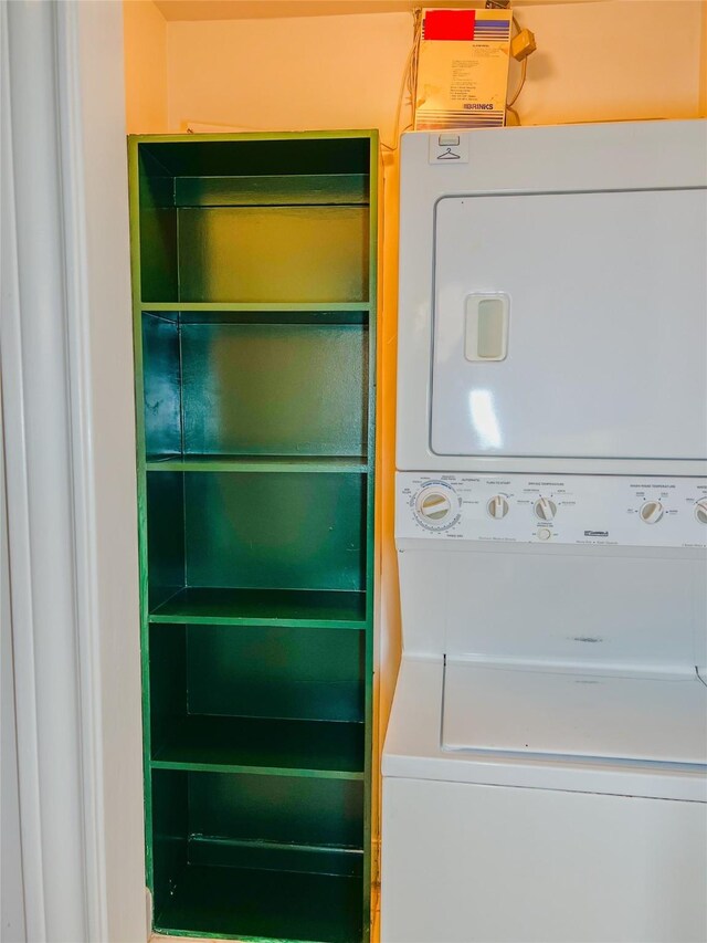 washroom featuring stacked washer / drying machine