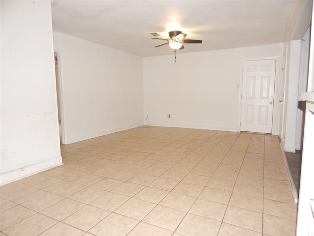 tiled spare room featuring ceiling fan