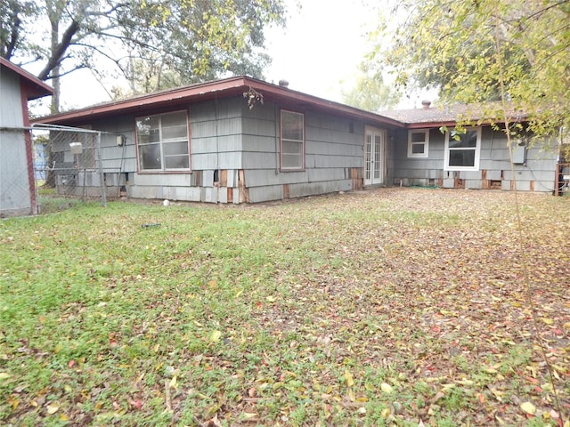 rear view of house with a yard