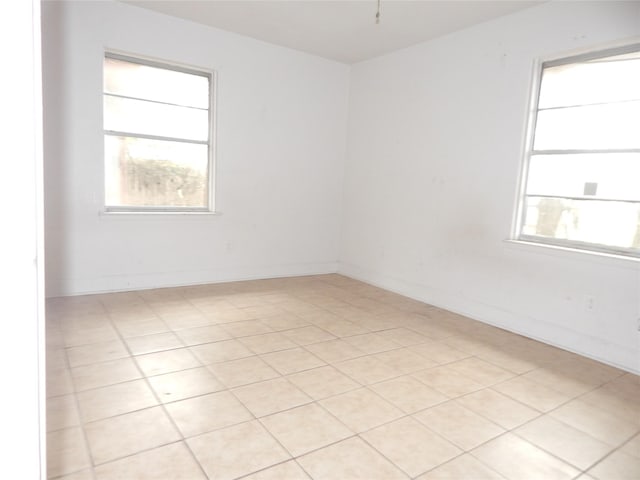 unfurnished room featuring light tile patterned flooring