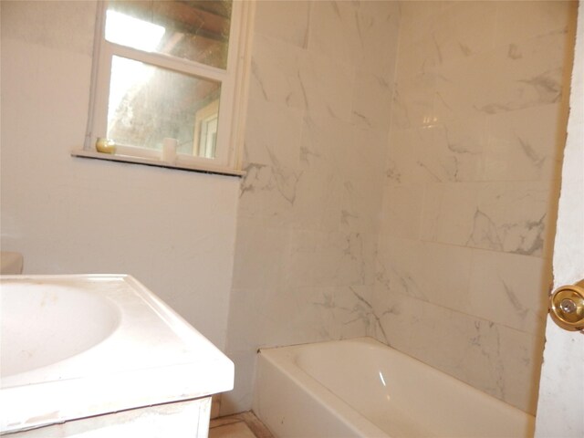 bathroom featuring a tub and vanity