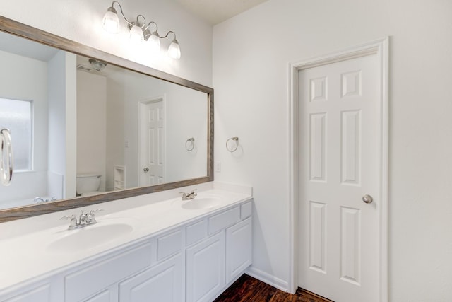 bathroom featuring hardwood / wood-style floors, vanity, and toilet