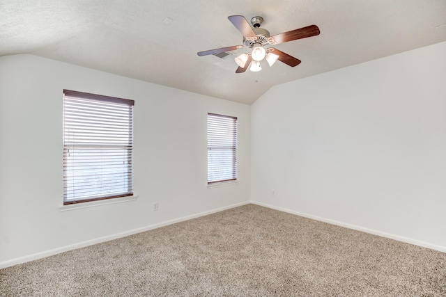 spare room featuring carpet flooring, ceiling fan, a textured ceiling, and vaulted ceiling