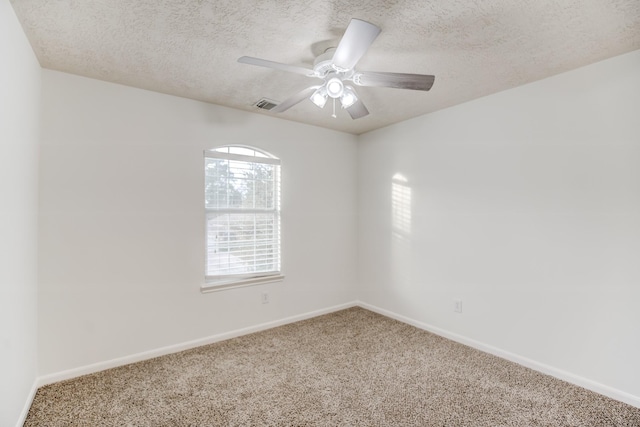 carpeted spare room with ceiling fan and a textured ceiling