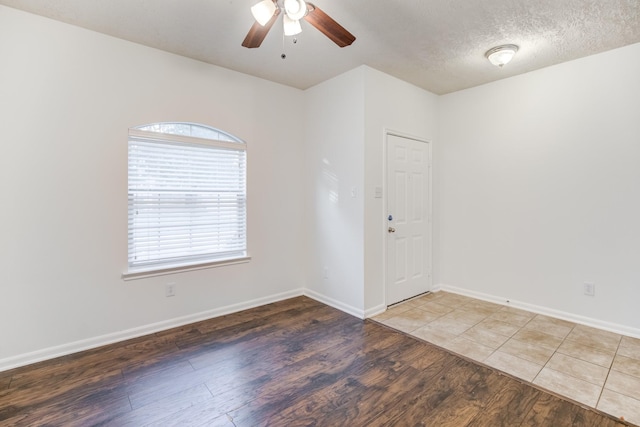 unfurnished room featuring a textured ceiling, hardwood / wood-style flooring, and ceiling fan