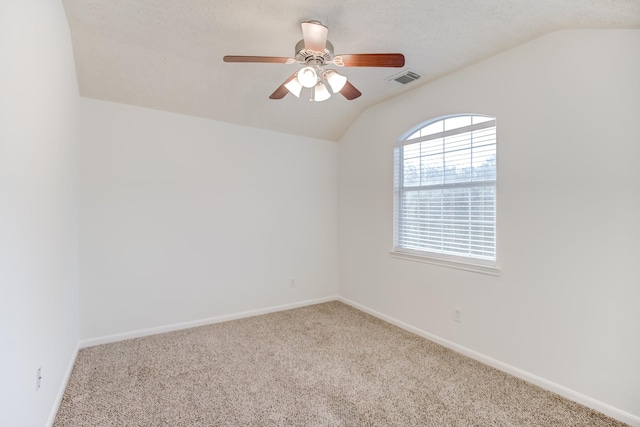 unfurnished room with lofted ceiling and a textured ceiling