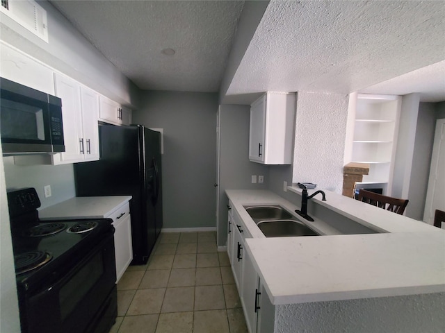 kitchen featuring sink, black range with electric cooktop, white cabinets, a textured ceiling, and light tile patterned floors