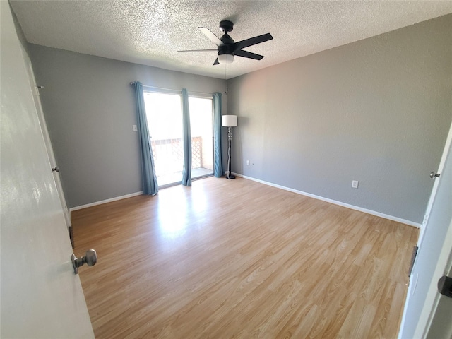 unfurnished room with a textured ceiling, light hardwood / wood-style flooring, and ceiling fan