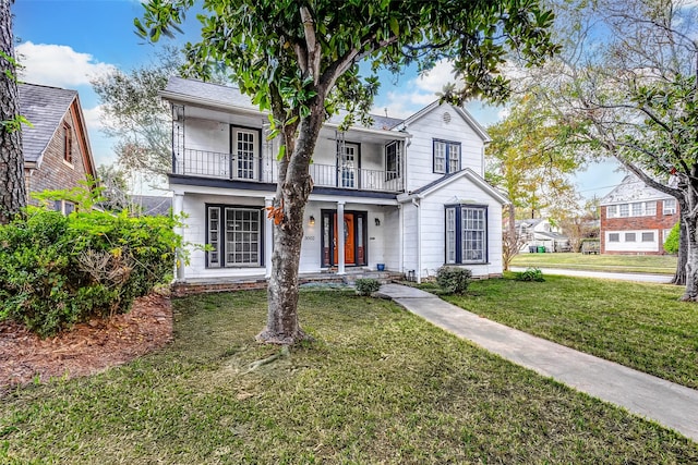 view of front of house featuring a front yard, a porch, and a balcony