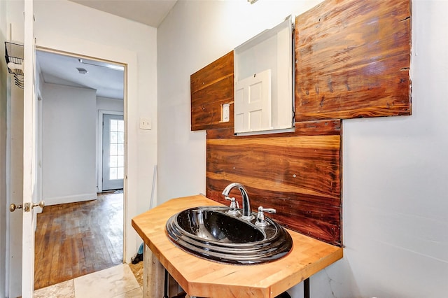 bathroom with hardwood / wood-style flooring and sink