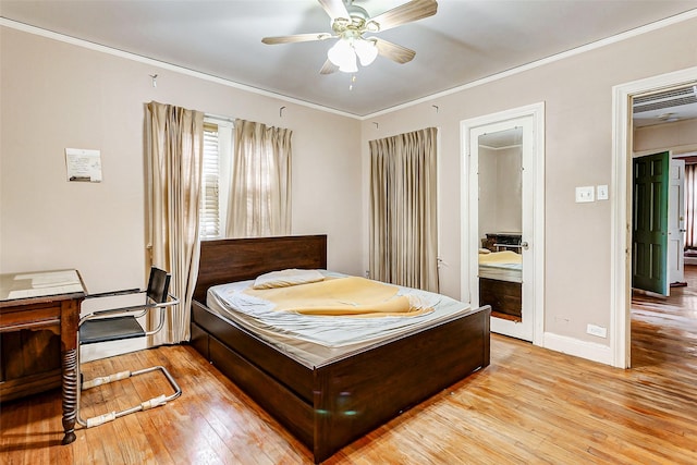 bedroom with ensuite bath, ceiling fan, ornamental molding, and light wood-type flooring