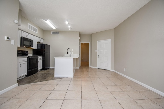 kitchen featuring black appliances, sink, light tile patterned floors, a textured ceiling, and white cabinetry