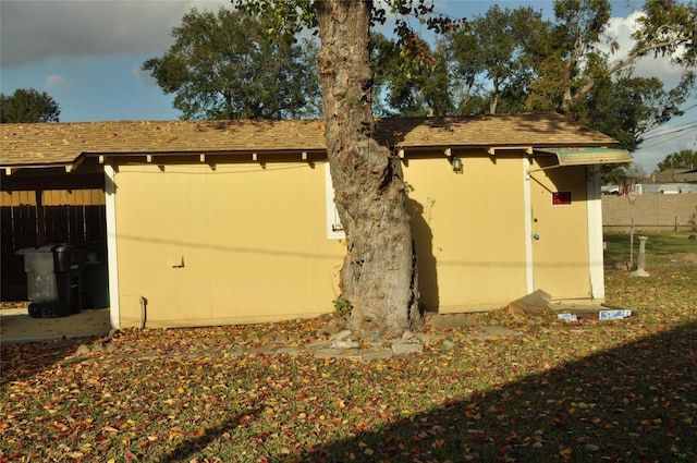 view of side of property featuring a shed