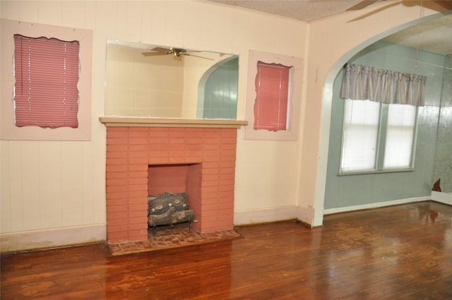 unfurnished living room featuring a fireplace and dark hardwood / wood-style flooring