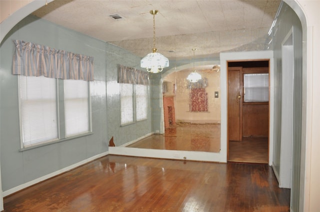 unfurnished dining area featuring hardwood / wood-style floors