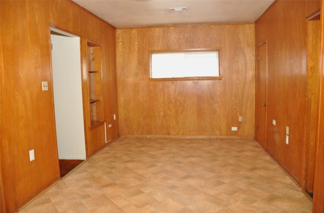 spare room with wooden walls