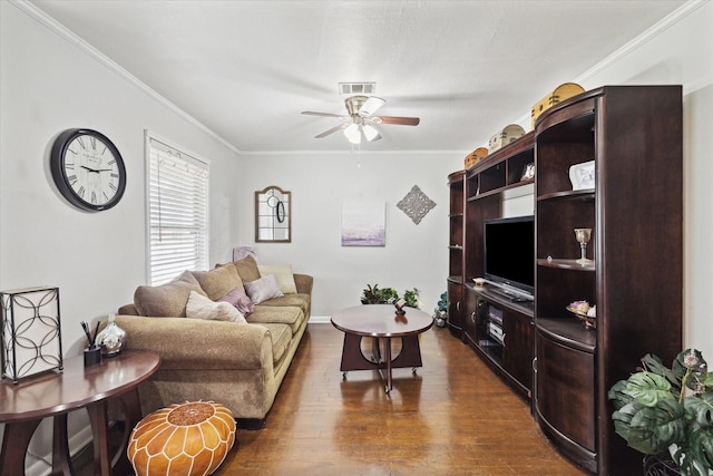 living room with dark hardwood / wood-style flooring, ceiling fan, and crown molding