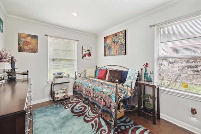 bedroom featuring crown molding and dark wood-type flooring