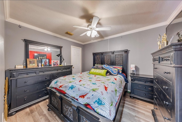 bedroom featuring a textured ceiling, ceiling fan, light wood-type flooring, and crown molding