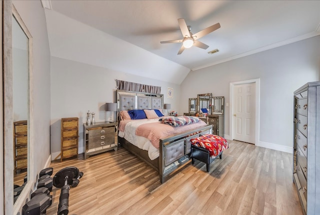 bedroom featuring ceiling fan, light hardwood / wood-style floors, lofted ceiling, and crown molding