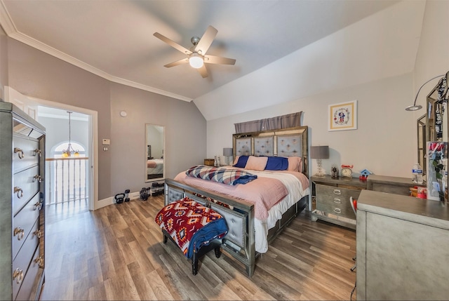 bedroom with wood-type flooring, vaulted ceiling, ceiling fan, and ornamental molding