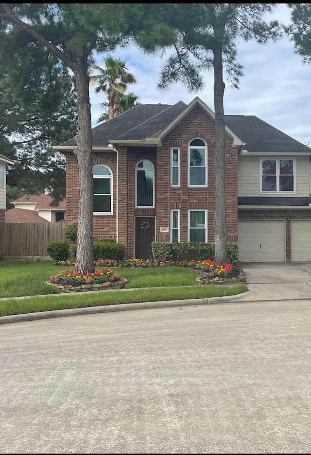 view of front of property featuring a front lawn and a garage