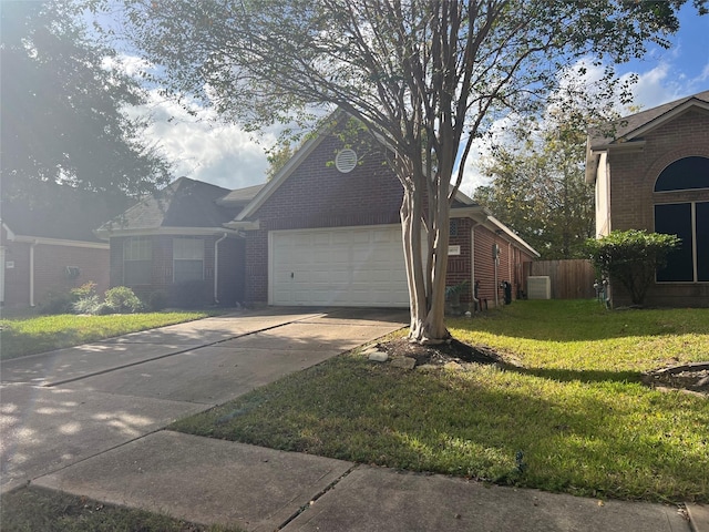 view of front of property with a front yard and a garage